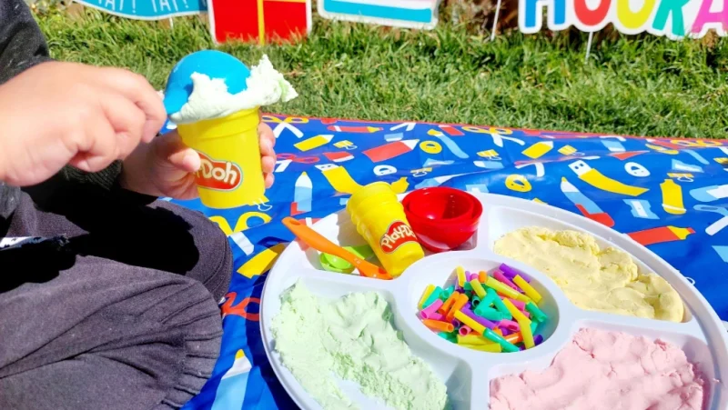 Kid playing with silky ice cream cloud dough